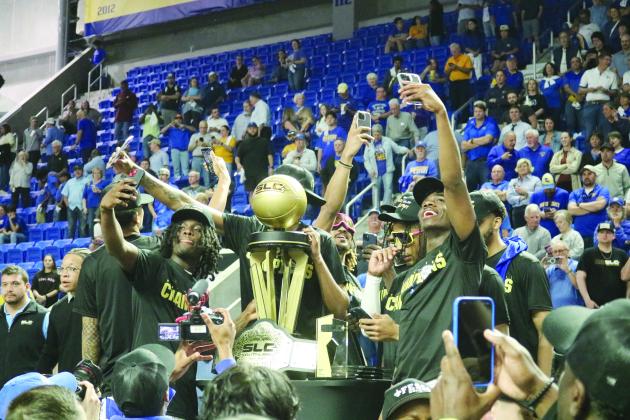 McNeese State University basketball players take selfies with the Southland Conference Basketball Championship trophy after defeating Nicholls State University, 92-76, on Wednesday, March 13. (Gazette photo by Tony Marks)