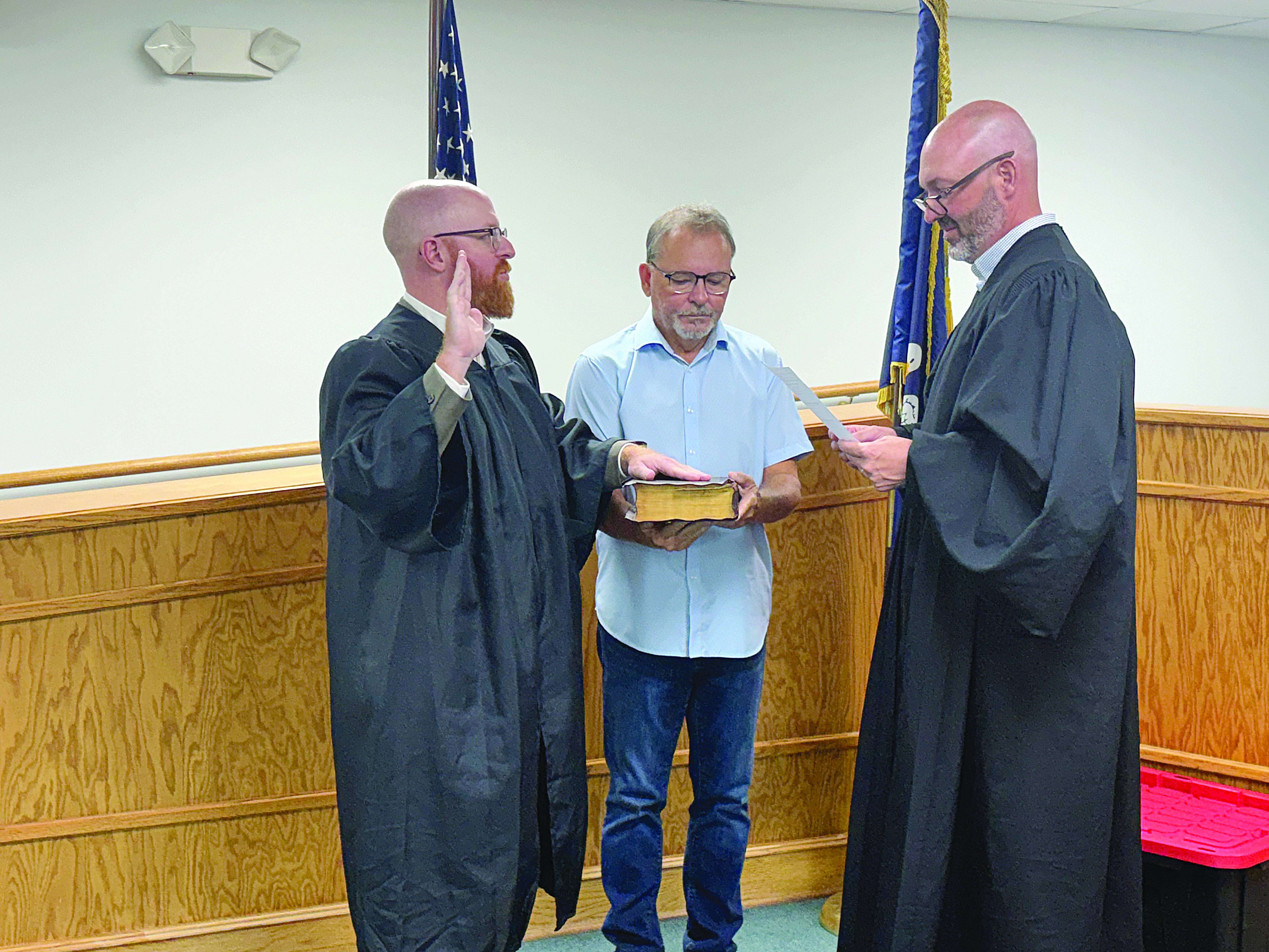 Christopher Ludeau (left) takes the oath of office after being appointed as magistrate of the Village of Pine Prairie. Administering the oath during the village council meeting held Thursday, September 10, is Ville Platte City Court Judge and Village of Pine Prairie Attorney Gregory Vidrine (right). Holding the Bible is Pine Prairie Mayor Quint West (center).