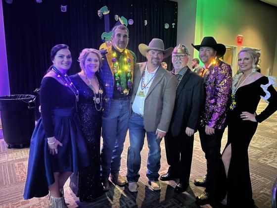 Pictured from left in the left photo are Shallie Carson, Lelia Thrasher, Andy Carson, Derrick Thrasher, Mayor Lyle Nelson, of Bastrop, Texas, TJ Campbell, and Regina Pate while at the Taste of Mardi Gras Ball on Friday, February 2.