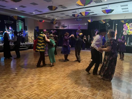 Pictured are members of the sellout crowd as they dance during the Taste of Mardi Gras Ball that also took place at the Convention and Exhibit Center. (Gazette photo by Tony Marks)