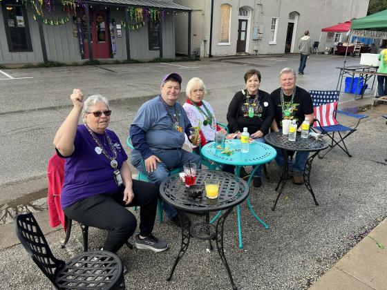 Pictured from left in the left photo are Evangeline Parish Tourist Commission Vice President Wanda Verrette, Ray Duplechain, Stella Ardoin, Gwen Perron, and Mike Perron as they enjoy a Salute to Fred’s Lounge outside Gracie’s.