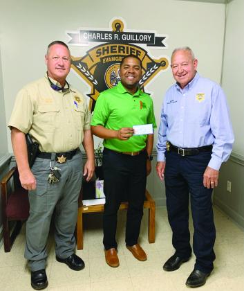 Pictured are Sheriff Charles Guillory (right) and Chief Deputy Scott Fontenot (left) as they receive a check from Lorenzo Richard (center), coalition coordinator, for $10,000.00 which has been applied toward the effort of raising awareness for underage drinking in the parish. (Photo courtesy of EPSO)