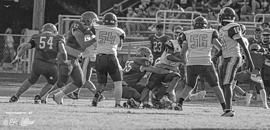The Bearcat defense is in action earlier this year.  Shown (from left) are Pierre Berzas (54), Scott Berzas (62), and Wyatt Bertrand (55).