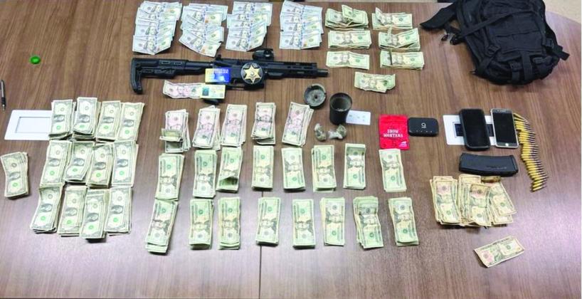 Pictured are the firearm, narcotics, and currency which were seized following the arrest of Brusly resident Calvin B. Jarvis. (Photo courtesy of EPSO)