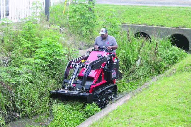 Ville Platte Mayor Ryan Leday Williams is pictured as he clears a portion of a canal located at the intersection of Tate Cove Road and E. Jefferson Street. (Gazette photo by Tony Marks)