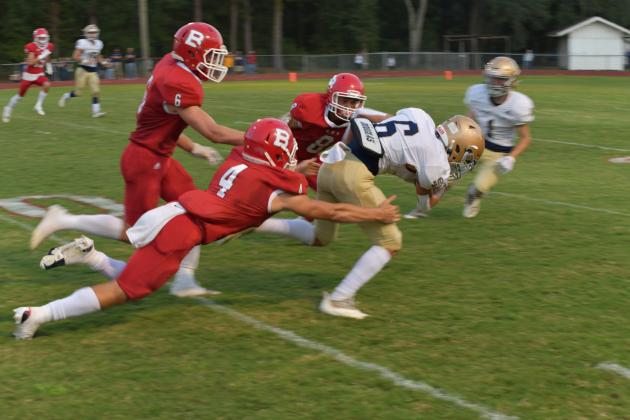 Sacred Heart’s Landon LeBlanc (6) fights for extra yardage after a catch as he jets past Basile’s Luc Johnson (4), Parker Fontenot (6), and Gavin Ardoin (8) in the Trojans’ thrilling win over the Bearcats (Photo courtesy of Tonya Ortego)