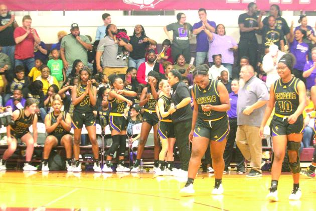 Ville Platte native and head coach of the Oakdale Lady Warriors Renotta Edwards (center right) celebrates with her team’s only senior Marlee Hart (center left) after defeating top seeded White Castle in the LHSAA Girls’ Basketball Quarterfinals. With the win, Edwards advanced to the former Top 28 for the first time in her playing/ coaching career. (LSN photo by Tony Marks)