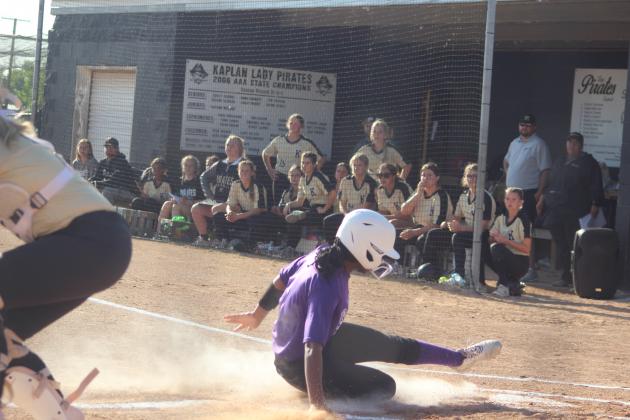 Destiny Lavigne (1) slides home for the only Ville Platte run in the Lady Bulldogs’ playoff loss to Kaplan Monday night. Lavigne, the lead off hitter and starting left fielder, went 1-for-2 at the plate to go with her run scored. (Gazette photo by Rhett Manuel)