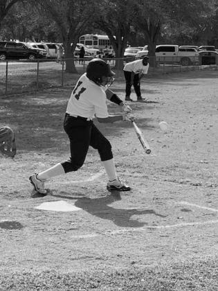 Kenzie Stevens (11) takes a swing at the plate in recent action for her Ville Platte Lady Bulldog softball team. (Gazette photo by Rhett Manuel)