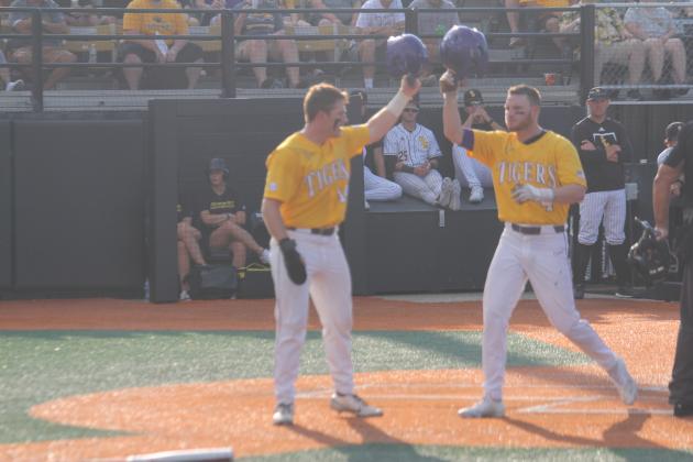 Cade Doughty  (4) gets a helmet salute from teammate Eric Berry (14) after both runners scored on Doughty’s two-run home run in the top of the first inning in LSU’s 8-4 loss to Southern Miss on Sunday, June 5. (Gazette photo by Tony Marks)