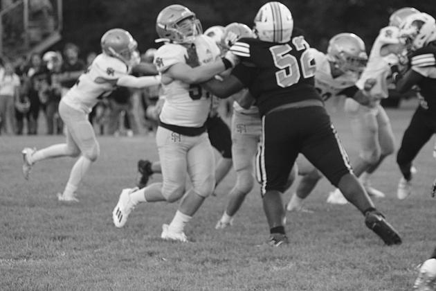 A Sacred Heart lineman makes a play against a Pine Prairie player in the jamboree. The Trojans take the field for the first time this season tomorrow night against Marksville at Soileau-Landry Field. (Gazette photo by Rhett Manuel)