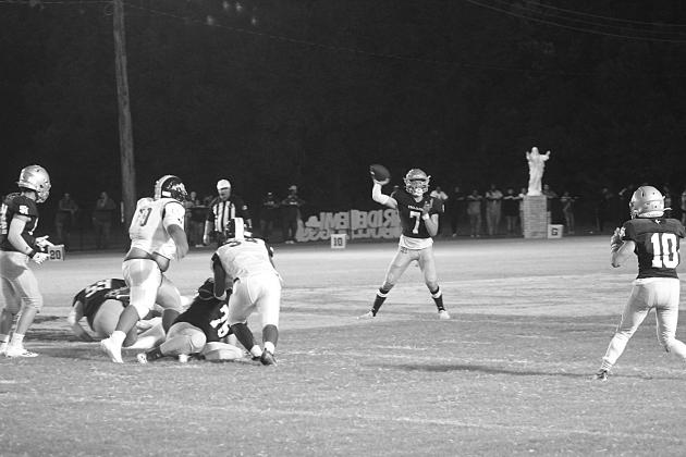 Trojan quarterback Hayden Droddy (7) delivers a pass to Blake Hebert (10) in Sacred Heart’s 44-0 win over Ville Platte High in the resumption of the Tee Cotton Bowl. Droddy completed 6 of 8 passes for 142 yards and three passing touchdowns. He also rushed for 116 yards and two touchdowns. (Gazette photo by Rhett Manuel)