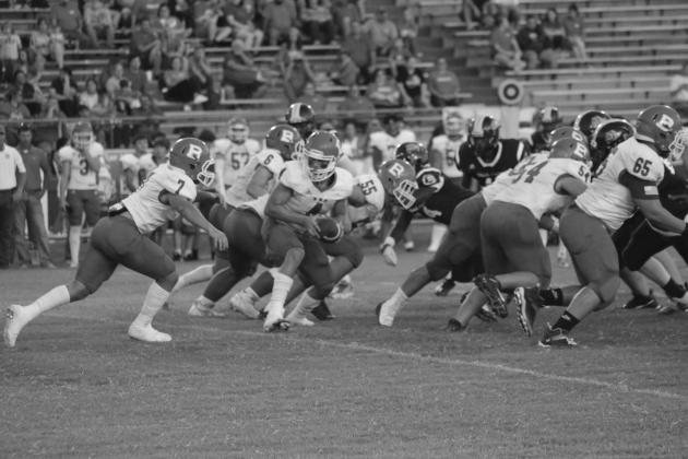 Basile quarterback Luc Johnson (4) hands the football off to Tucker Leblanc (7) last week against Ville Platte. This week, against Sacred Heart, the Bearcats fell 13-7. (Gazette photo by Rhett Manuel)