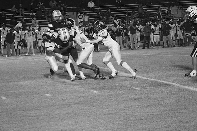 Several Ville Platte defensive players combine to make a stop against Pine Prairie in their matchup last week. The Bulldogs, now 1-1 in district play, travel to Mamou to battle the Green Demons, who are also 1-1 in district. (Gazette photo by Rhett Manuel)