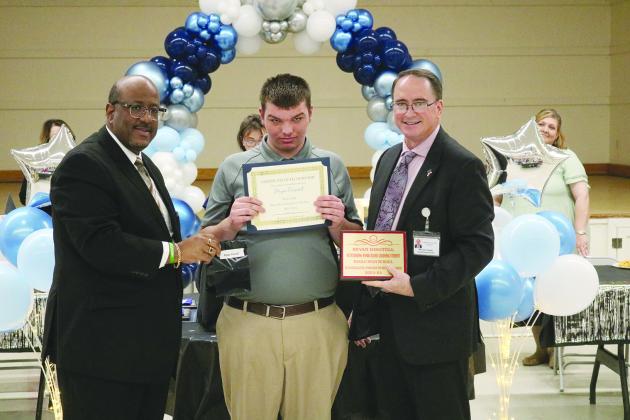 From left are Superintendent Lazard, work-based learning student of the year Bryan Disotell, and Assistant Superintendent Lombas.