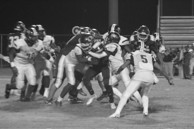 The Bulldog defense, led by Chance Fontenot (28), combines for a tackle of Charles Shird in Ville Platte’s 38-0 loss against Oakdale. (LSN photo by Tony Marks)