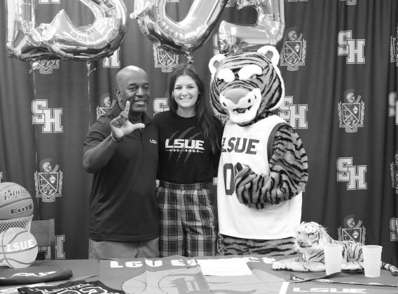 Kali Shiver (center) is pictured with LSUE women’s basketball head  coach Jahmel Samuels (left) and the Bengal mascot (right). (Gazette photo by Tony Marks)
