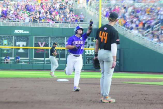 Gavin Dugas (8) points toward the LSU dugout after hitting a homerun against Tennessee.