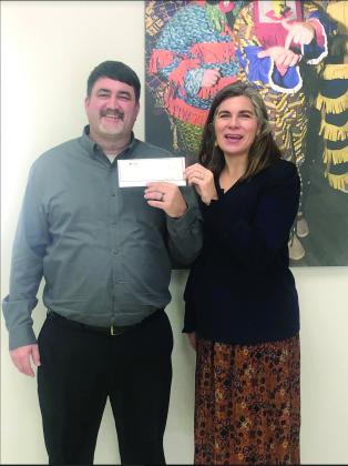 Donation is presented for Mardi Gras Social