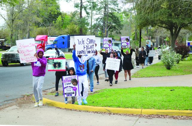 The peaceful protestors are pictured as they circle around the Evangeline Parish Courthouse seven times on Monday, March 11. The event was held in memory of Brittany Fontenot. (Gazette photo by Tony Marks)