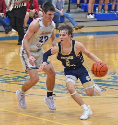 Sacred Heart’s Gabe Fontenot (2) dribbles the ball down the court in the Trojans’ season opening win against Northside Christian in Crowley. Fontenot scored 17 points on the night. (LSN photo by Chris Quebedeaux)