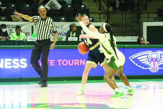 Jodie Landry (23) prepares to inbound the basketball while being guarded by a Lady Kitten.