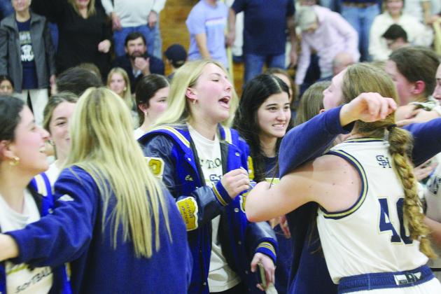 Members of the Sacred Heart Lady Trojan basketball team, including Taylor Darbonne, Olivia Tate, Ava Johnson, and Rose Ardoin, celebrate after advancing to the state semi-finals in Hammond. (Gazette photos by Rhett Manuel)