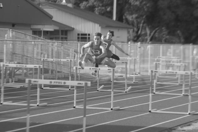 Tyler Newman and Landon Fontenot, both of Basile, are pictured as they compete in the 110m hurdles during the parish track meet held at Pine Prairie High School. (Gazette photo by Rhett Manuel)