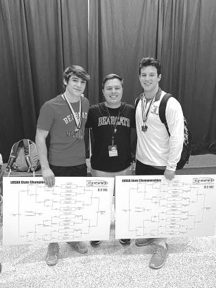 Bearcat wrestling coach Ben Bertrand congratulates seniors Luc Johnson (left) and Christian Bergeron (right) on their individual state championships in their respective weight classes. Both claimed titles for the second consecutive year. (Photo by Tracy Veillon)