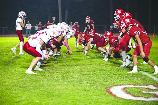 RED AND WHITE VS. RED AND WHITE - The Basile Bearcat defense (at right) lines up against the Port Barre Red Devils in last week’s BHS Homecoming football game. (Photo by Tonya Ortego)