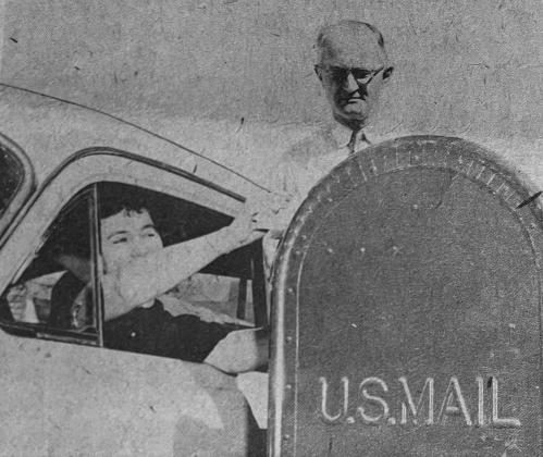 DRIVE-IN POSTAL SERVICE INSTALLED - Mrs. Burkeman Veillon, a well known legal secretary in Ville Platte, tried out the new drive-in service as Postmaster P.F. Morein checked the mailbox for convenience and distance. Veillon joked, “You should fix it so we can pick up our mail  this way, too.” Morein commented in reply, “I’ll have to write Washington about it.” (Gazette file photo)