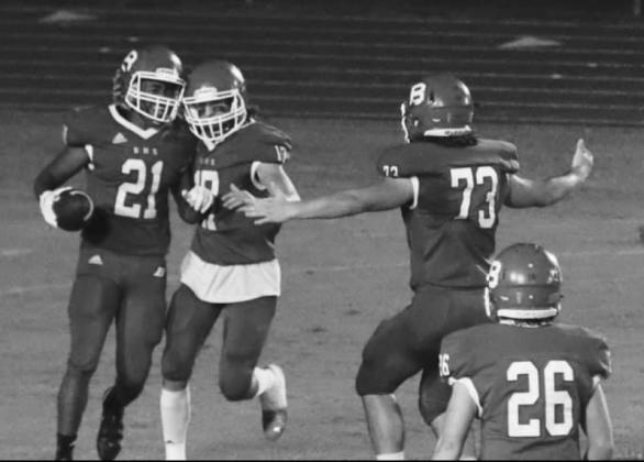 CELEBRATION - Basile’s Luke Fontenot (17) and Christian Bergeron (73) celebrate with Jared Thomas (21) following  one of Thomas’ five receptions from quarterback Luc Johnson. Ashton Deaville (26)  is in the foreground. (Photo by Nikki Johnson)