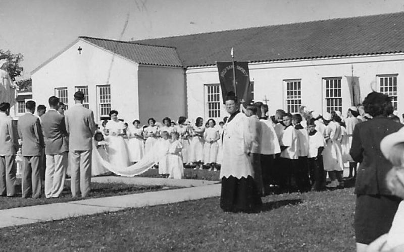 CROWNING MARY - Fifty-seven first communicants plus the Sodality girls and the Holy Name boys, the altar boys, the men and women of the CCD, the local nuns, and other congregants were among the procession for the 1952 May crowning at St. Augustine Church. (Chunkie’s Photography, courtesy of Redlich family)