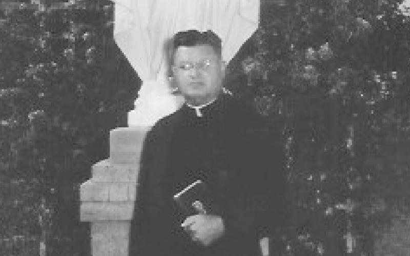 Father Armand Cyr stands in front of the Our Lady of Grace statue. (circa 1946) (Photo by the late Melvin Hester)