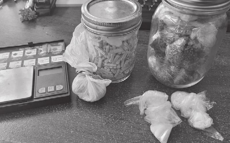 Pictured are items seized following a recent arrest in Turkey Creek. Among the items are mason jars containing 49.9 grams of marijuana and 532.5 xanax pills. (Photo courtesy of Turkey Creek Police Department)