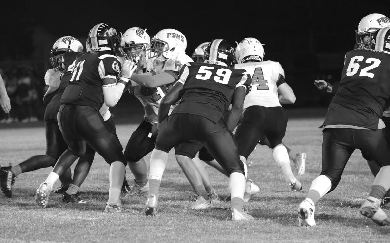 Members of the Ville Platte Bulldog defensive unit held Port Barre to 22 points last week helping the team record its second win of the season. The Bulldogs, tonight, head to Church Point. (Photo courtesy of Susan Angelle Photography)