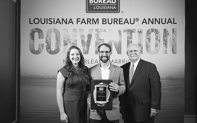 Raquella (left) and Clint Manuel (center) are pictured as they receive the Louisiana Farm Bureau Federation Young Farmers and Ranchers Excellence in Agriculture award at the 102nd annual convention held in New Orleans. (Photo courtesy of Louisiana Farm Bureau Federation)