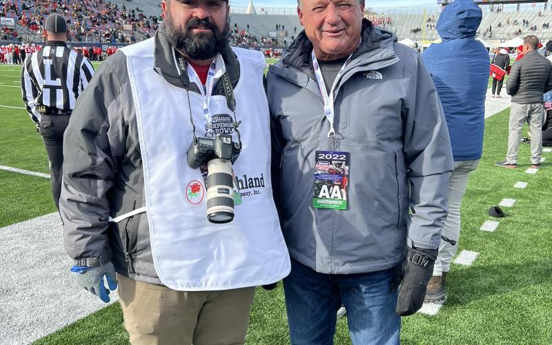Ville Platte Gazette editor Tony Marks (left) is pictured with former LSU football coach Ed Orgeron (right) on the sideline of the Radiance Technologies Independence Bowl played in Shreveport on Friday, December, 23. (Photo submitted)