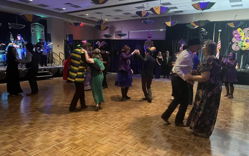 Pictured are members of the sellout crowd as they dance during the Taste of Mardi Gras Ball that also took place at the Convention and Exhibit Center. (Gazette photo by Tony Marks)