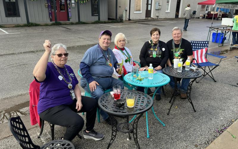 Pictured from left in the left photo are Evangeline Parish Tourist Commission Vice President Wanda Verrette, Ray Duplechain, Stella Ardoin, Gwen Perron, and Mike Perron as they enjoy a Salute to Fred’s Lounge outside Gracie’s.