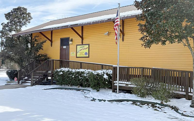 In the top right photo, icicles drape the edge of the roof at the Louisiana Swamp Pop Museum, in Ville Platte, as the snow and ice begins to melt on Thursday.