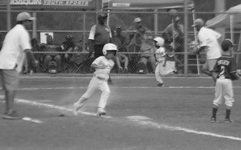 Amari Carr (9) scores on an RBI single from Emmett Lafleur (13) to give the Ville Platte 7U Coach Pitch All Stars a 4-2 lead over Shelby County in the Dixie Youth Region III World Series. Shelby County, though, won 9-8 in extra innings, on Saturday, July 22, and eliminated Ville Platte from the tournament. (Gazette photo by Tony Marks)