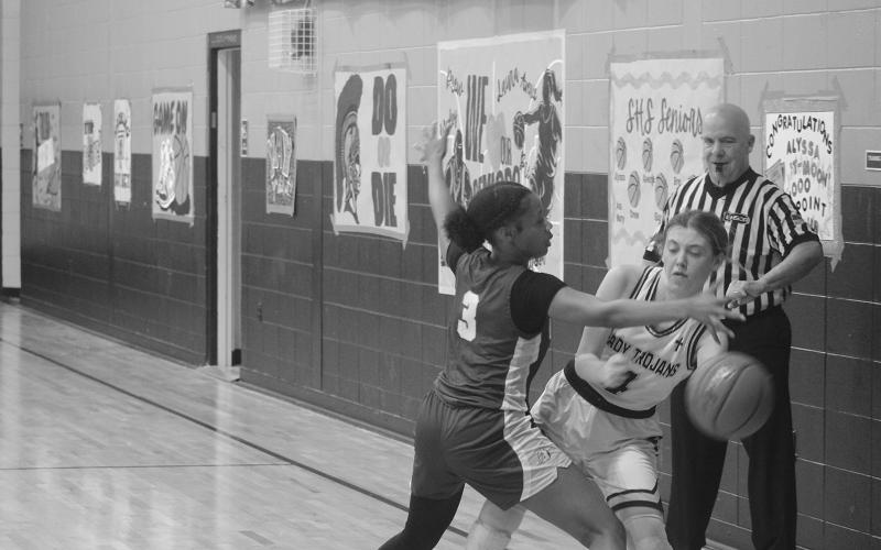 Averie Pitre (4) prevents the basketball from going out of bounds for the Lady Trojans in their win over Ascension Catholic. With the win, the team reached the quarterfinals for the second time in three years. (Gazette photo by Tony Marks)