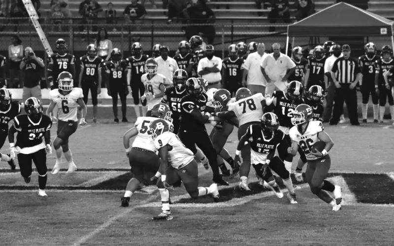 Ashton Deaville (26)  follows a block from Horace Edwards (9) during Basile’s victory over Ville Platte’s Bulldogs last week. (Photo by Nikki Johnson)
