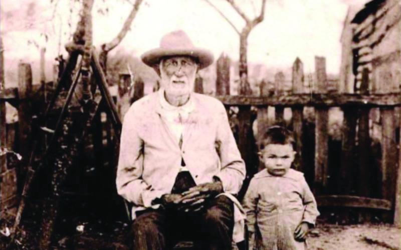 Auguste Louis Jeansonne (left) is pictured with one of his young family members. He was a Confederate soldier who had at least 23 children and over 100 grandchildren. He was also a sharecropper who passed away 100 years ago and is buried on the property he farmed in L’Anse Aux Pailles. (Photo courtesy of Carissa Morgan)