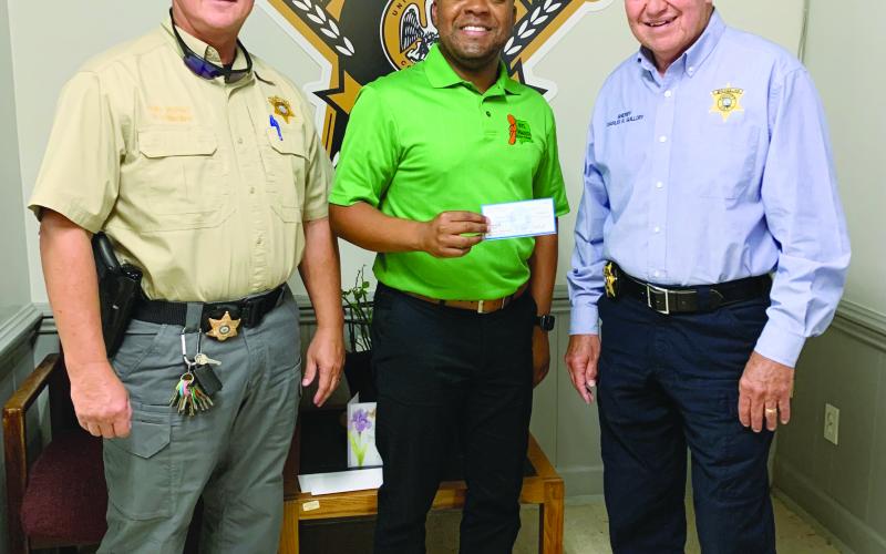 Pictured are Sheriff Charles Guillory (right) and Chief Deputy Scott Fontenot (left) as they receive a check from Lorenzo Richard (center), coalition coordinator, for $10,000.00 which has been applied toward the effort of raising awareness for underage drinking in the parish. (Photo courtesy of EPSO)