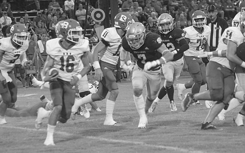 Trojan linebacker Cole Tate (7) goes in for a tackle on Basile’s wide receiver Gage Craton (16). (Gazette photo by Rhett Manuel)