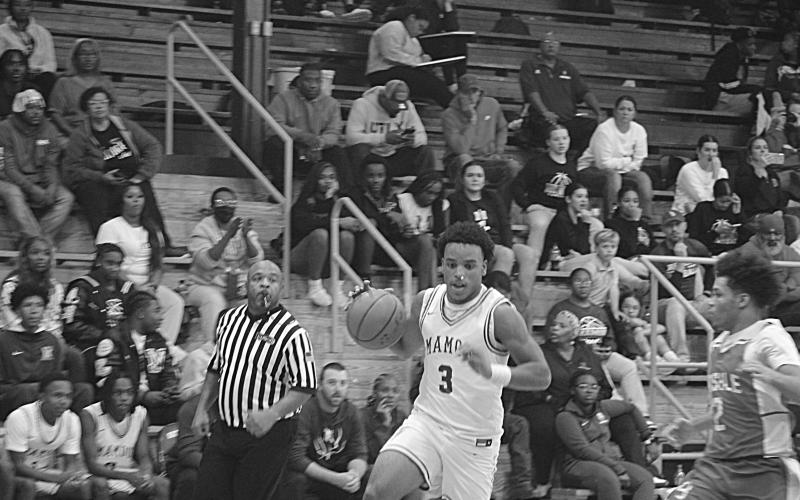 Mamou’s Zamaurri Brown (3) drives toward the goal in a game against Basile during the parish basketball tournament at Sacred Heart. (Gazette photo by Tony Marks)