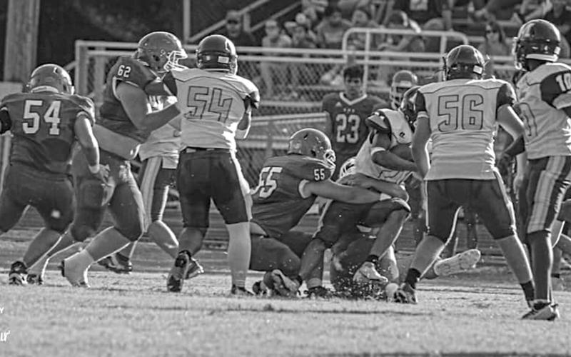 The Bearcat defense is in action earlier this year.  Shown (from left) are Pierre Berzas (54), Scott Berzas (62), and Wyatt Bertrand (55).