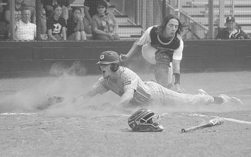 Caden Askey (7) slides underneath a tag to score Pine Prairie’s second run in the top of the first inning in Game 3 against Berwick on Saturday. (Gazette photo by Tony Marks)
